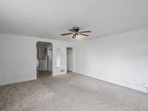 #29 (Basement Studio): Basement studio bedroom featuring arched walkways, carpet floors, a walk in closet, and ceiling fan