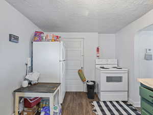 #39 (Basement 1-bedroom): Kitchen with white tile countertops, green cabinetry,  and LVP flooring
