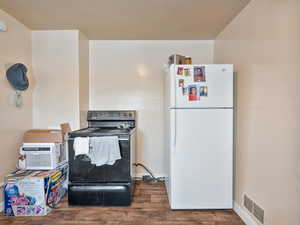 #31 (Upstairs 1-bedroom): Kitchen with freestanding refrigerator, black / electric stove, and LVP floors