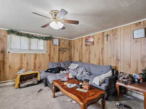 #39 (Basement 1-bedroom): Carpeted living room with wood paneling walls, and ceiling fan