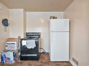 #31 (Upstairs 1-bedroom): Kitchen with freestanding refrigerator, black / electric stove, and LVP floors