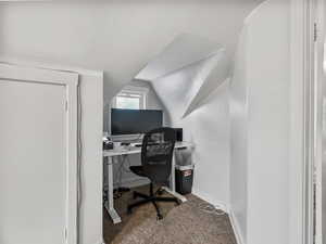 #37 (Upstairs 2-bedroom): Carpeted bedroom #2 office space featuring baseboards and vaulted ceiling