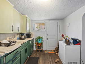 #39 (Basement 1-bedroom): Kitchen with white tile countertops, green cabinetry,  and LVP flooring
