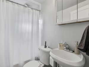 #37 (Upstairs 2-bedroom): Full bathroom featuring vanity and shower / tub combo with curtain