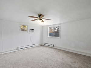 #29 (Basement Studio): Basement studio bedroom featuring natural light, carpet floors, and a baseboard radiator