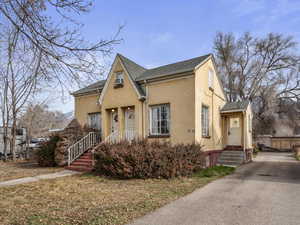 View of front of 4-Plex with stucco siding and asphalt shingles; showing the rear entrance to the 2 bedroom unit #37