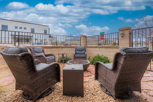 View of patio with an outdoor fire pit