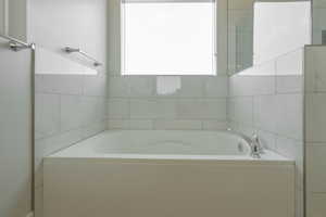 Full bath featuring a bath