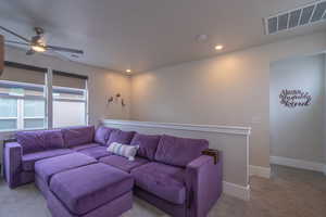 Living room featuring carpet, ceiling fan, and recessed lighting