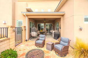 View of patio featuring a ceiling fan, a fire pit, and grilling area