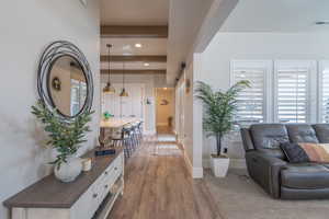 Corridor with dark wood finished floors and recessed lighting