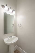 Bathroom with baseboards and wood finished floors