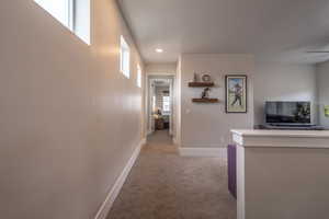 Corridor featuring light colored carpet and recessed lighting