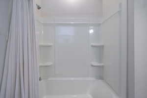 Bathroom featuring shower / bath combination with curtain