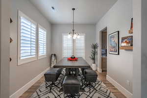 Dining room featuring a chandelier and wood finished floors