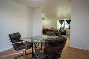 Dining area featuring wood finished floors and ceiling fan