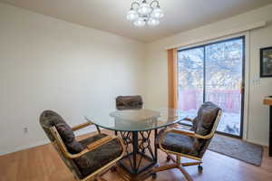 Dining space with a chandelier and wood finished floors