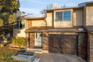 View of front of house featuring brick siding and an attached garage