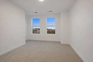 Unfurnished room featuring light colored carpet and baseboards