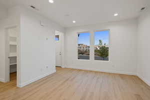 Unfurnished room with light wood-style floors and recessed lighting