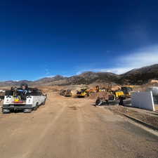 View of dirt / gravel road featuring a mountain view