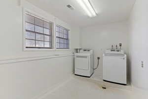 Laundry room with washer / dryer and tile patterned floors