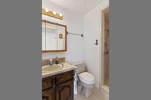 Bathroom with vanity, a stall shower, and light tile patterned floors
