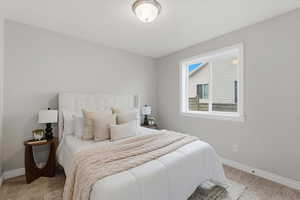 Carpeted bedroom with baseboards