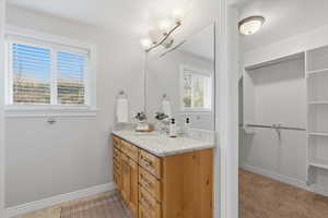 Bathroom featuring a spacious closet and vanity