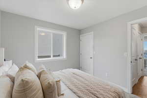 Bedroom with baseboards and wood finished floors