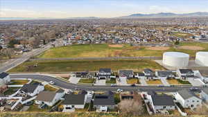 Aerial view of property's location featuring nearby suburban area and mountains