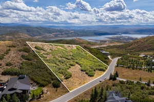 Aerial overview of property's location featuring property boundaries highlighted and a mountain backdrop