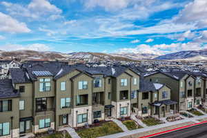 View of front of home featuring stone siding, board and batten siding, a mountain view