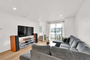 Living area with stairway, LVP floors, and recessed lighting