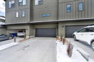 Board and batten siding, a garage, and concrete driveway
