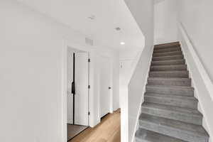 Entry Staircase with LVP floors and recessed lighting