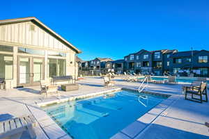 Community hot tub with a patio area, and pool