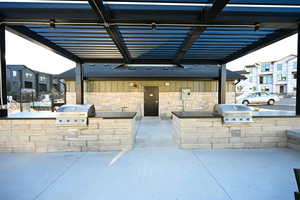View of patio / terrace with area for grilling and a pergola