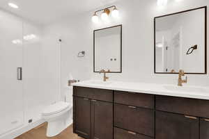 Primary bath featuring double vanity, and shower