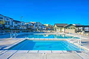 Community pool with a patio