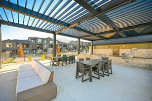 View of patio with outdoor dining area and area for grilling