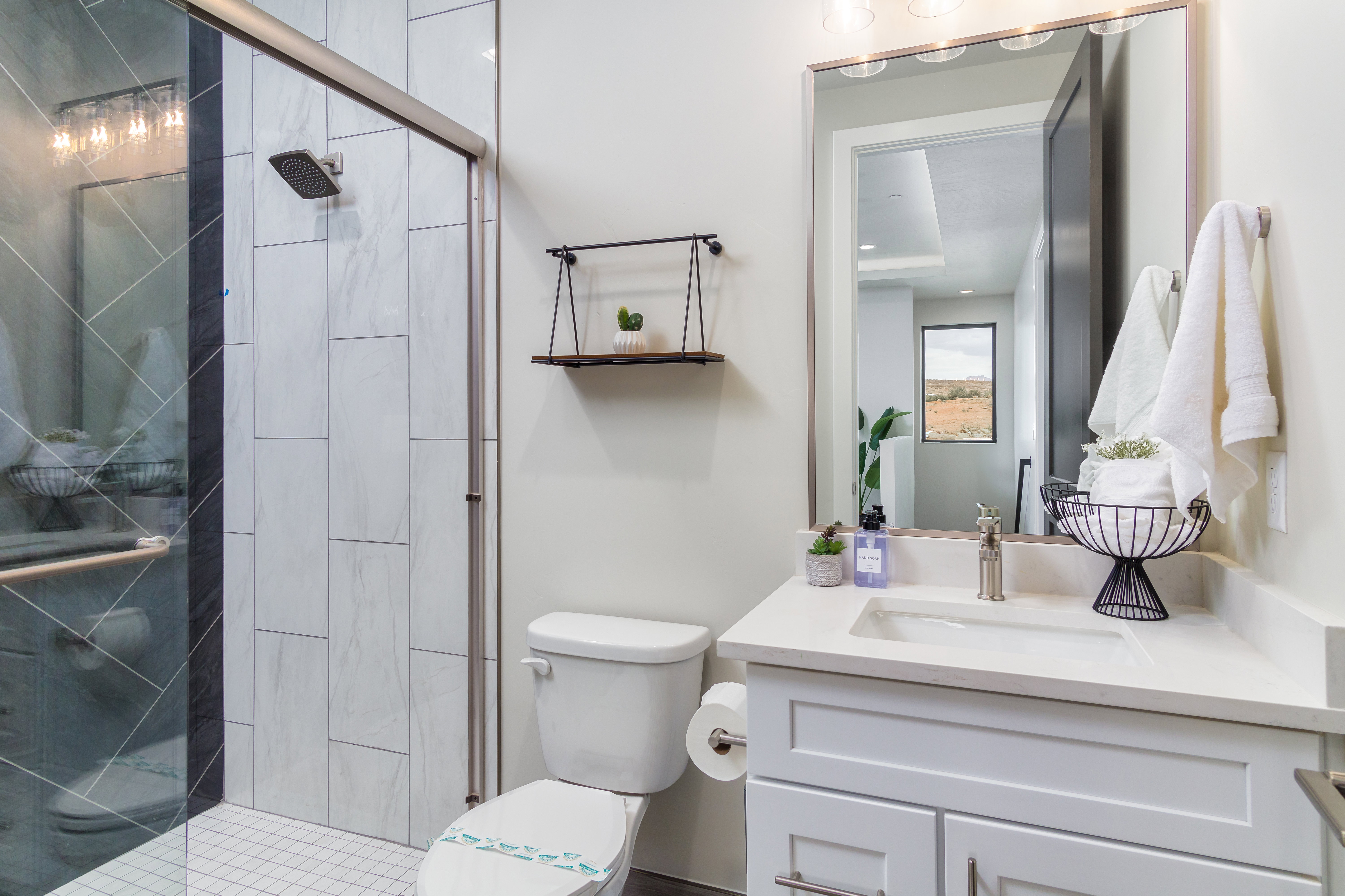 Full bath featuring a stall shower and vanity