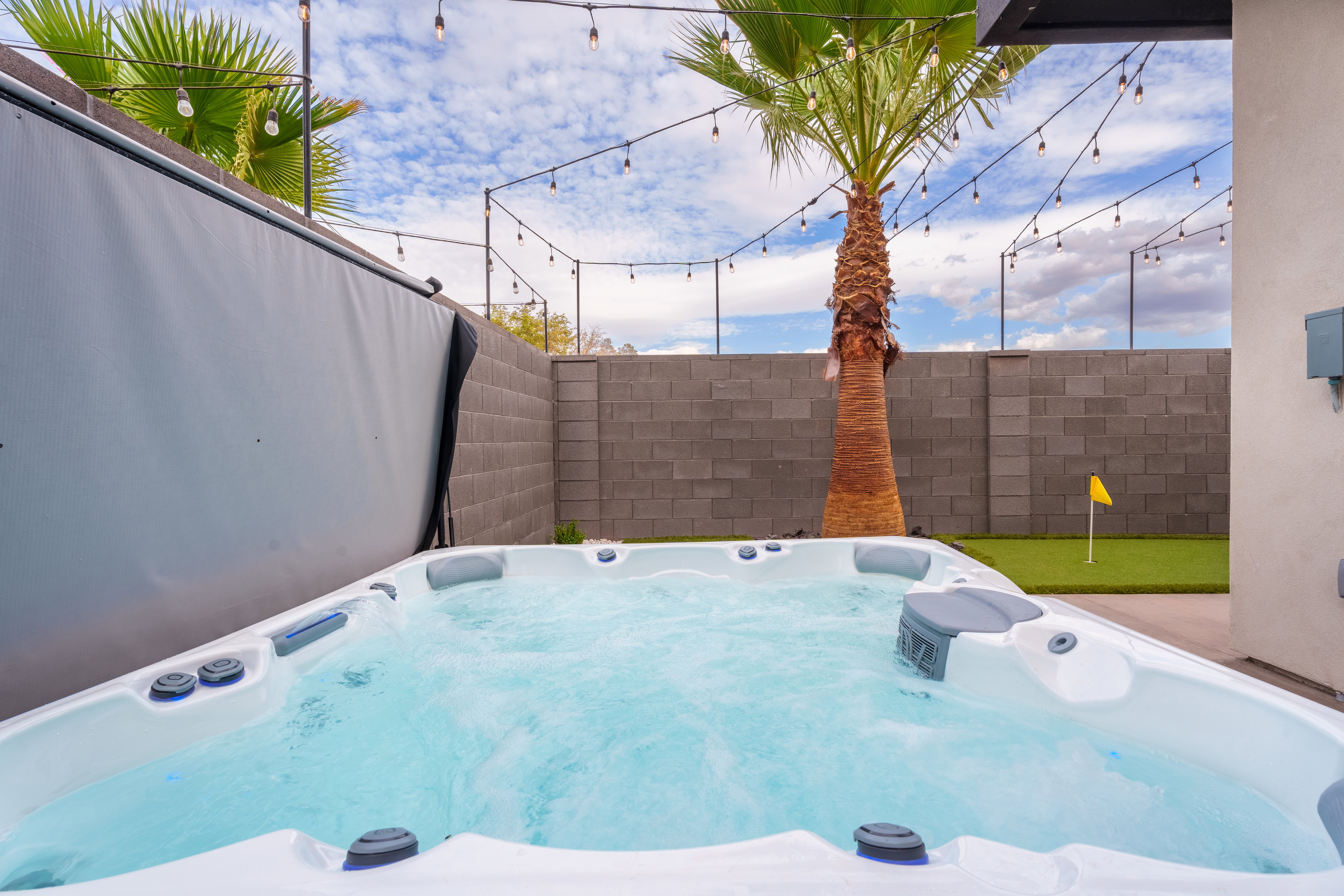 Exterior view of a fenced backyard and a jacuzzi