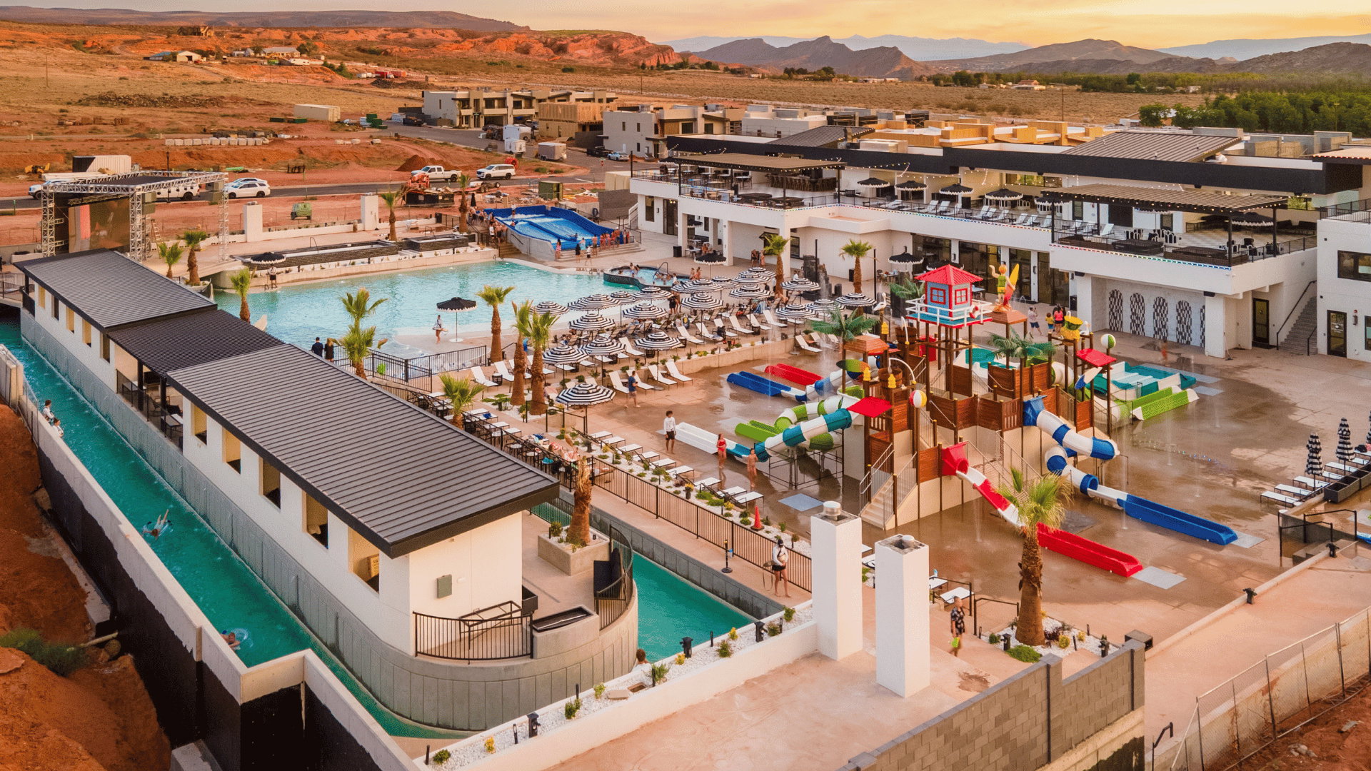 Aerial view at dusk of view of pool area and a mountain view