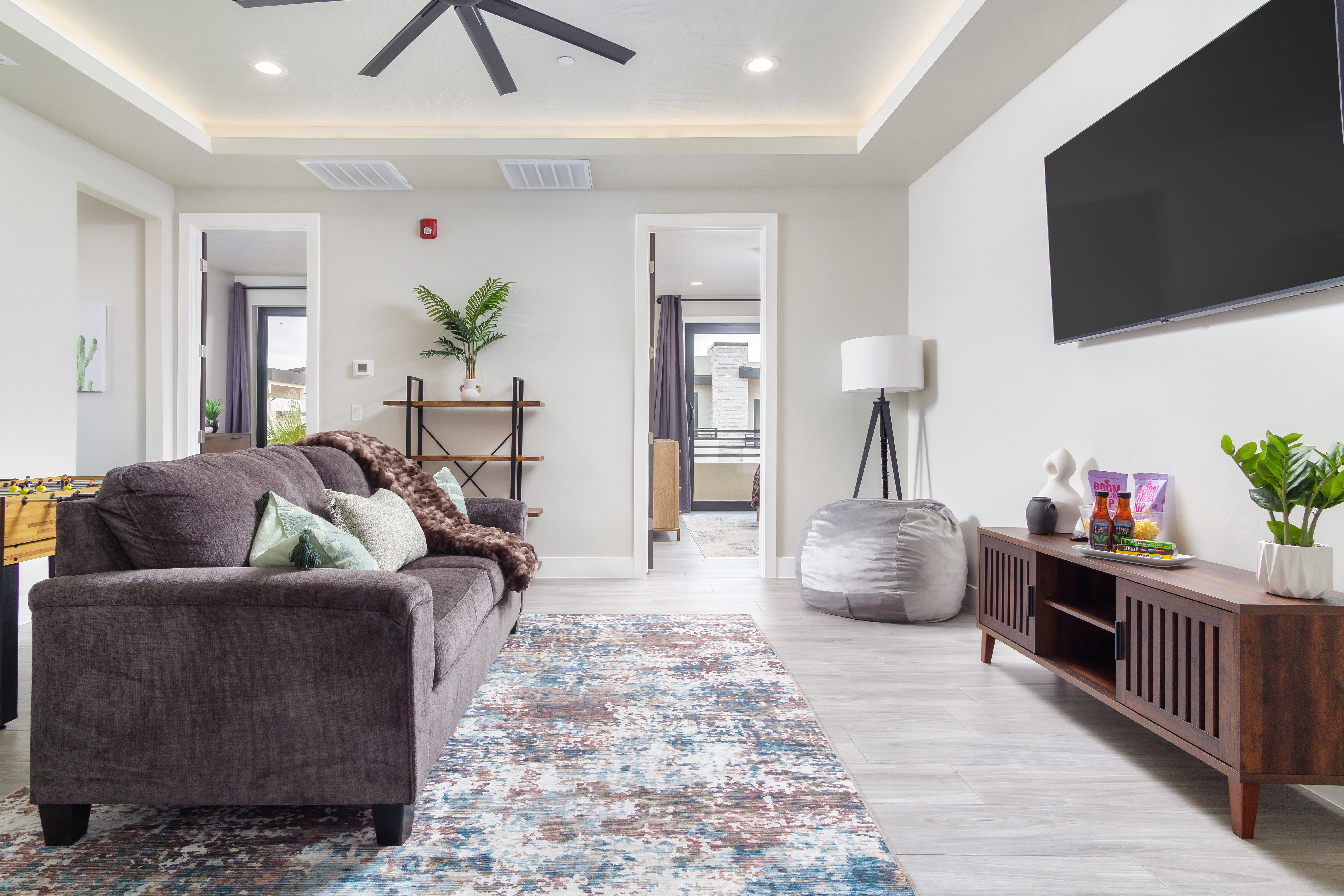 Living area featuring plenty of natural light, recessed lighting, light wood-style flooring, and a tray ceiling