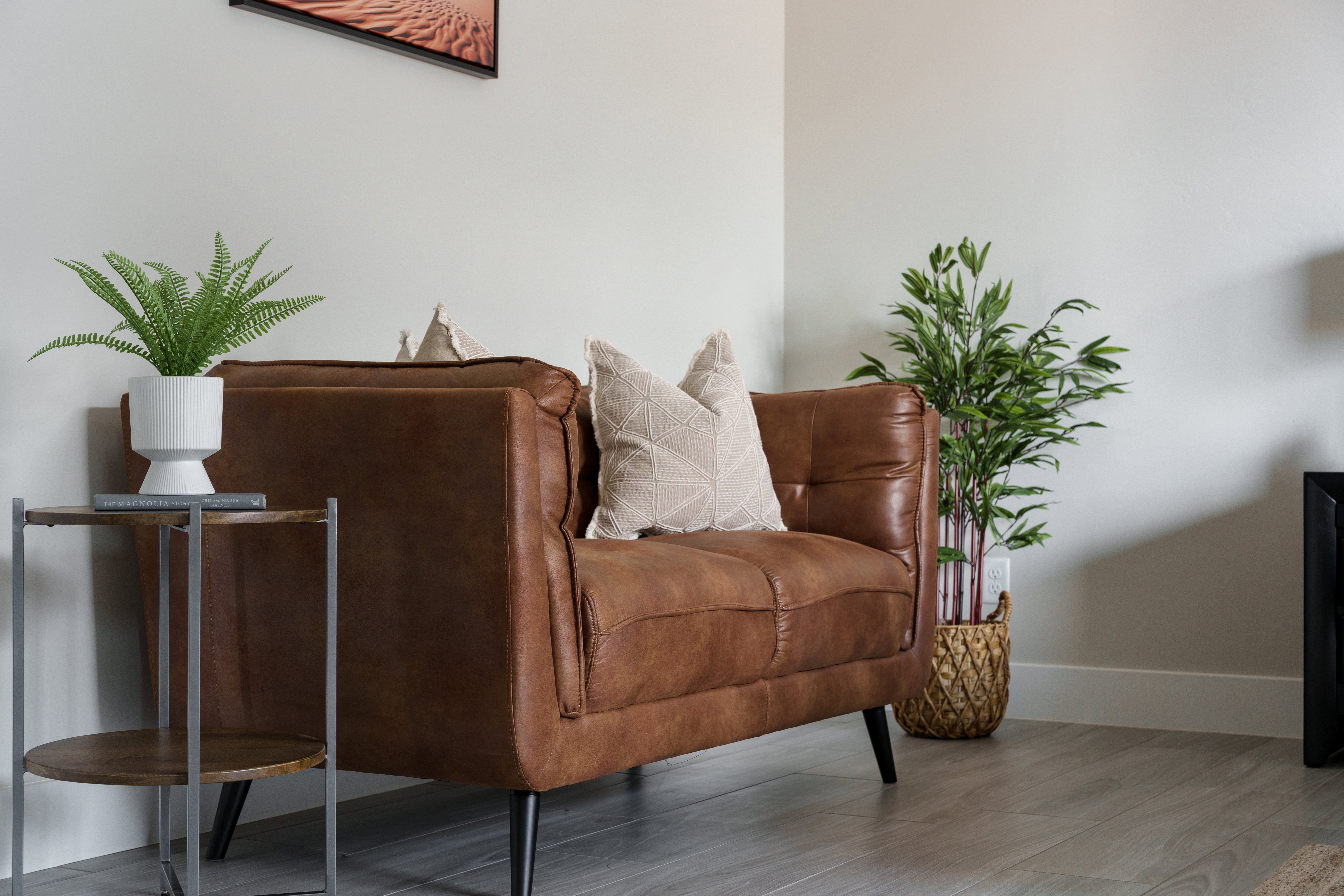 Living area with baseboards and wood finished floors