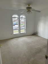 Spare room with carpet floors and ceiling fan