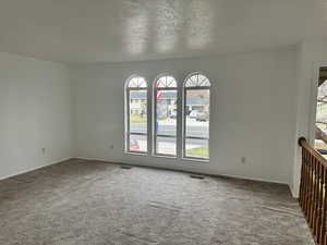 Unfurnished room with carpet