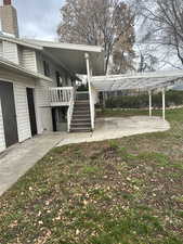 View of side of property featuring a patio area, deck and stairway