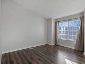Unfurnished room featuring dark wood finished floors